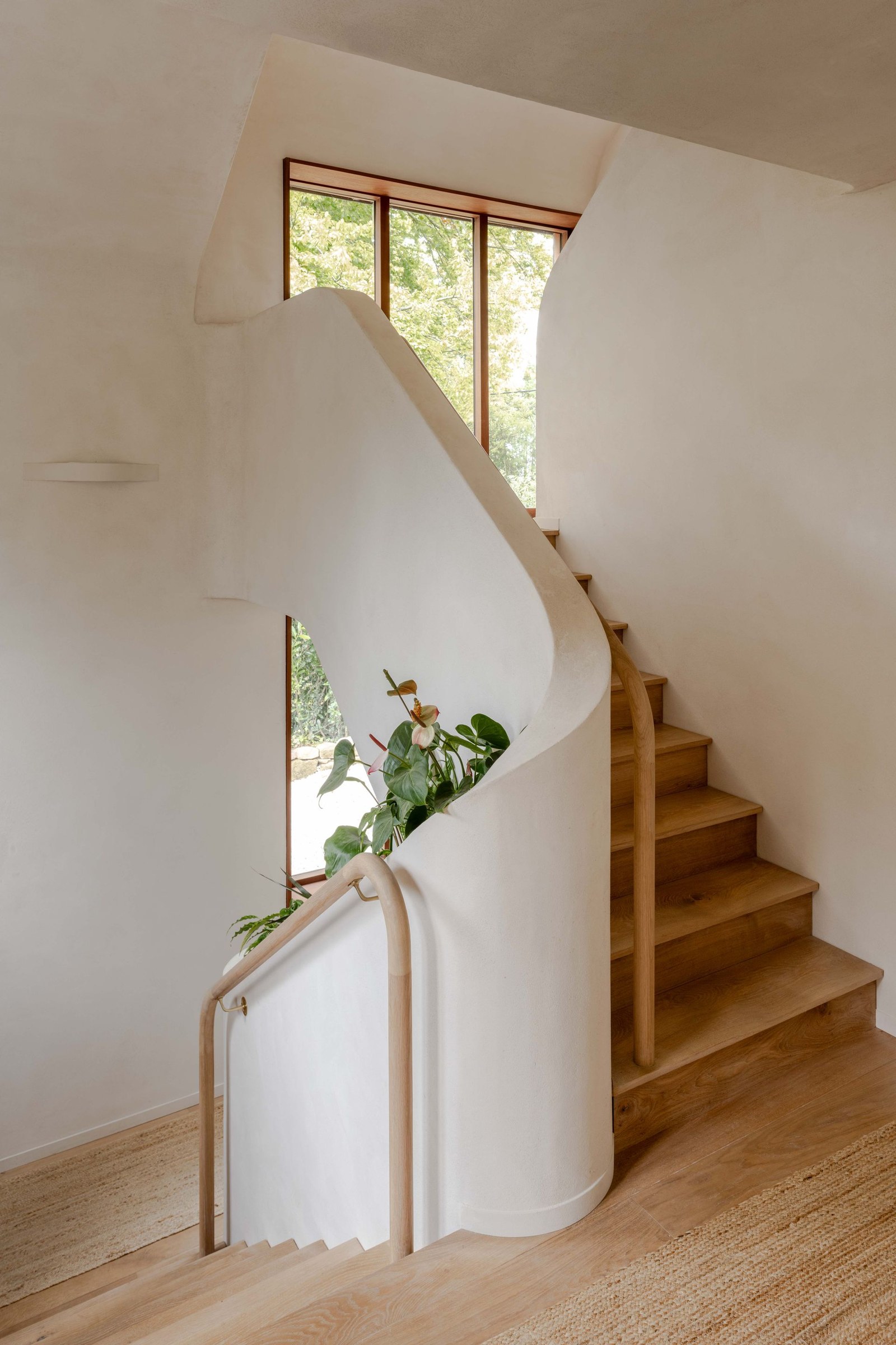 image of Clay Rise by Templeton Ford, a brick house with a curved roof in west sussex countryside