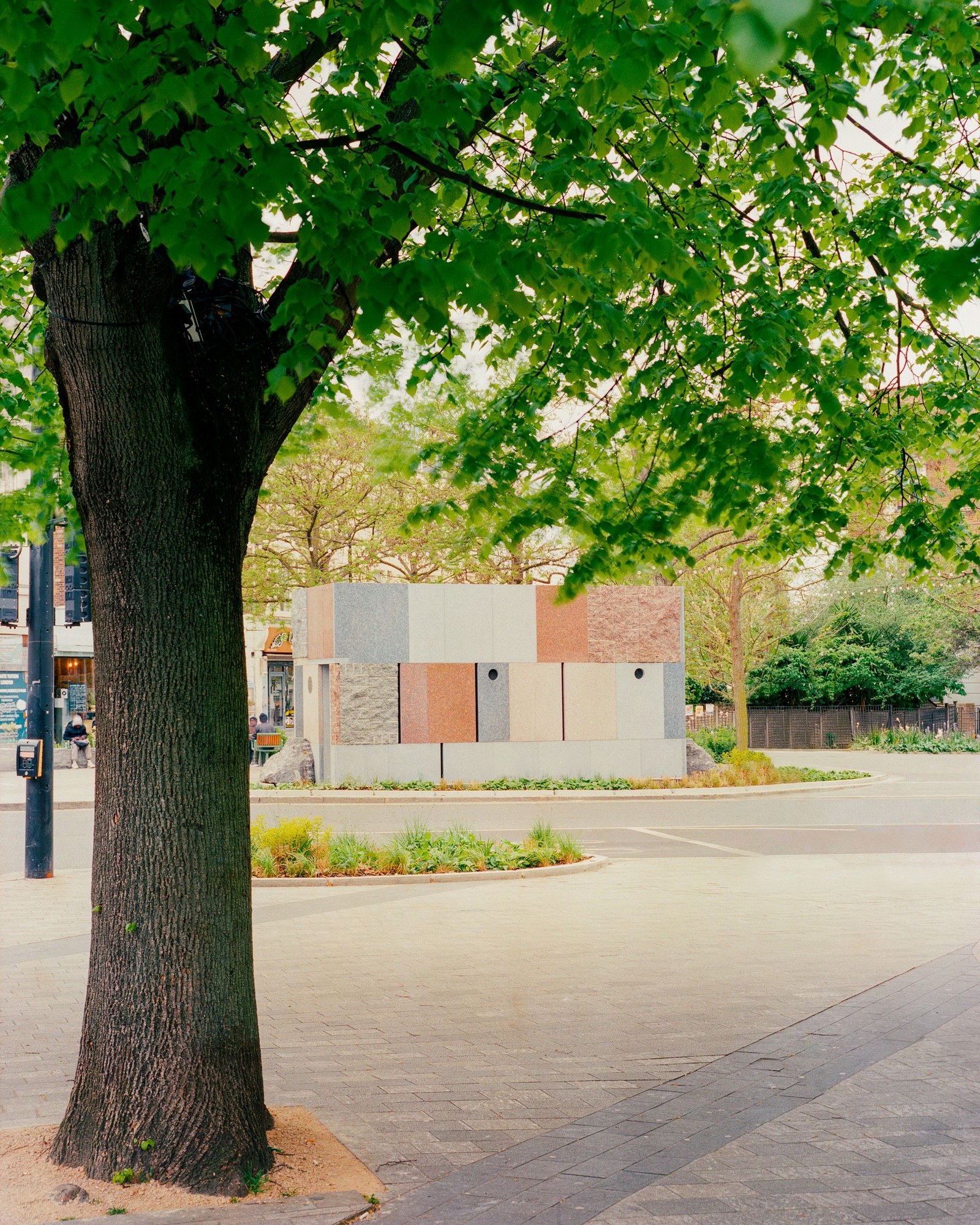 exterior view of Maida Vale public toilet by Studio Weave made out of reclaimed stone, looking like square patchwork