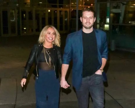 A woman and a man holding hands.
