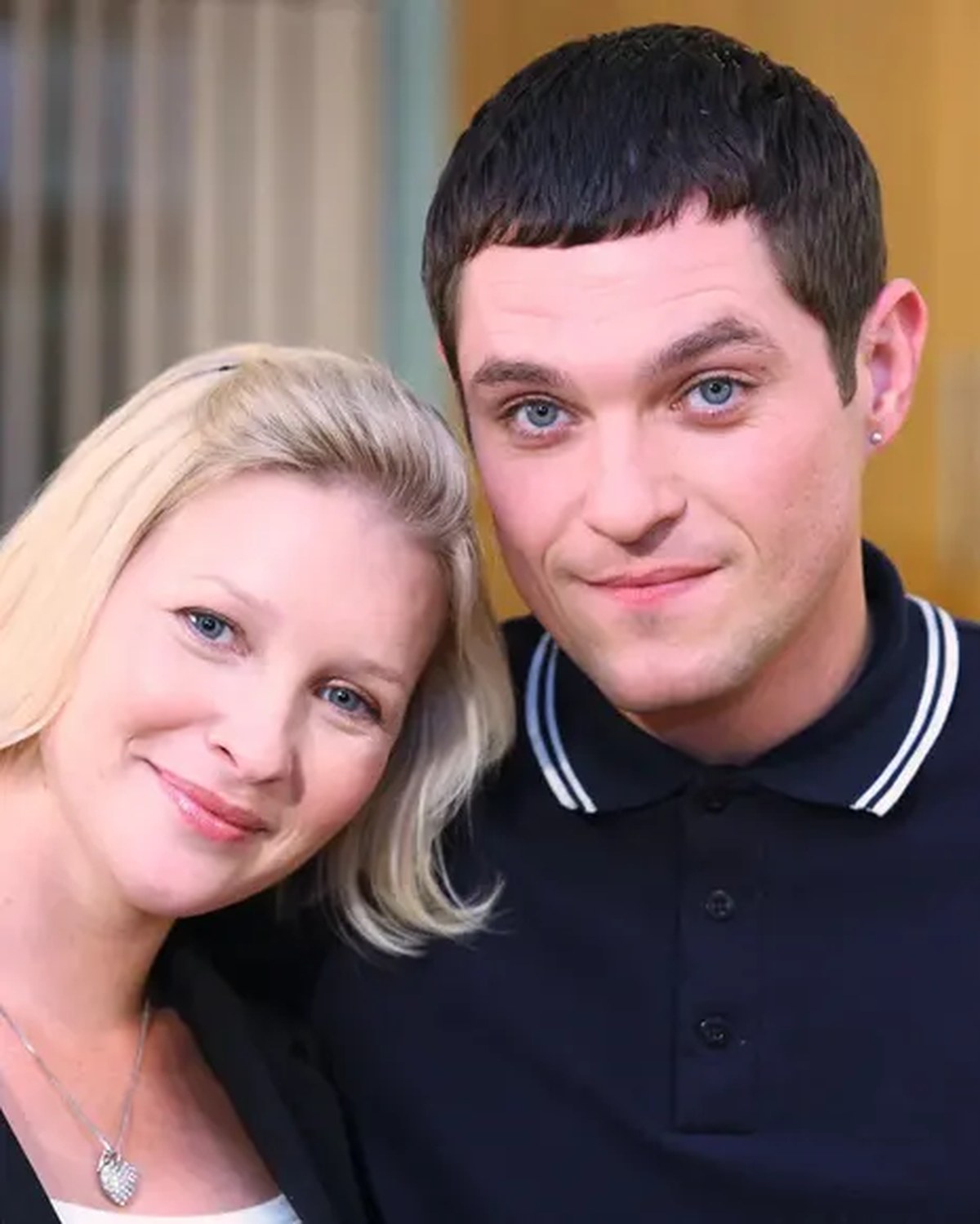 Page with her head tilted towards Horne's shoulder, him in a black polo shirt, her in a black jacket over a white T-shirt