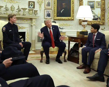 Trump gestures while speaking with lifeguard Ryder Williams in the Oval Office