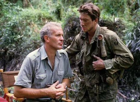 British film director John Irvin with American actor Dylan McDermott on the set of Hamburger Hill in 1986