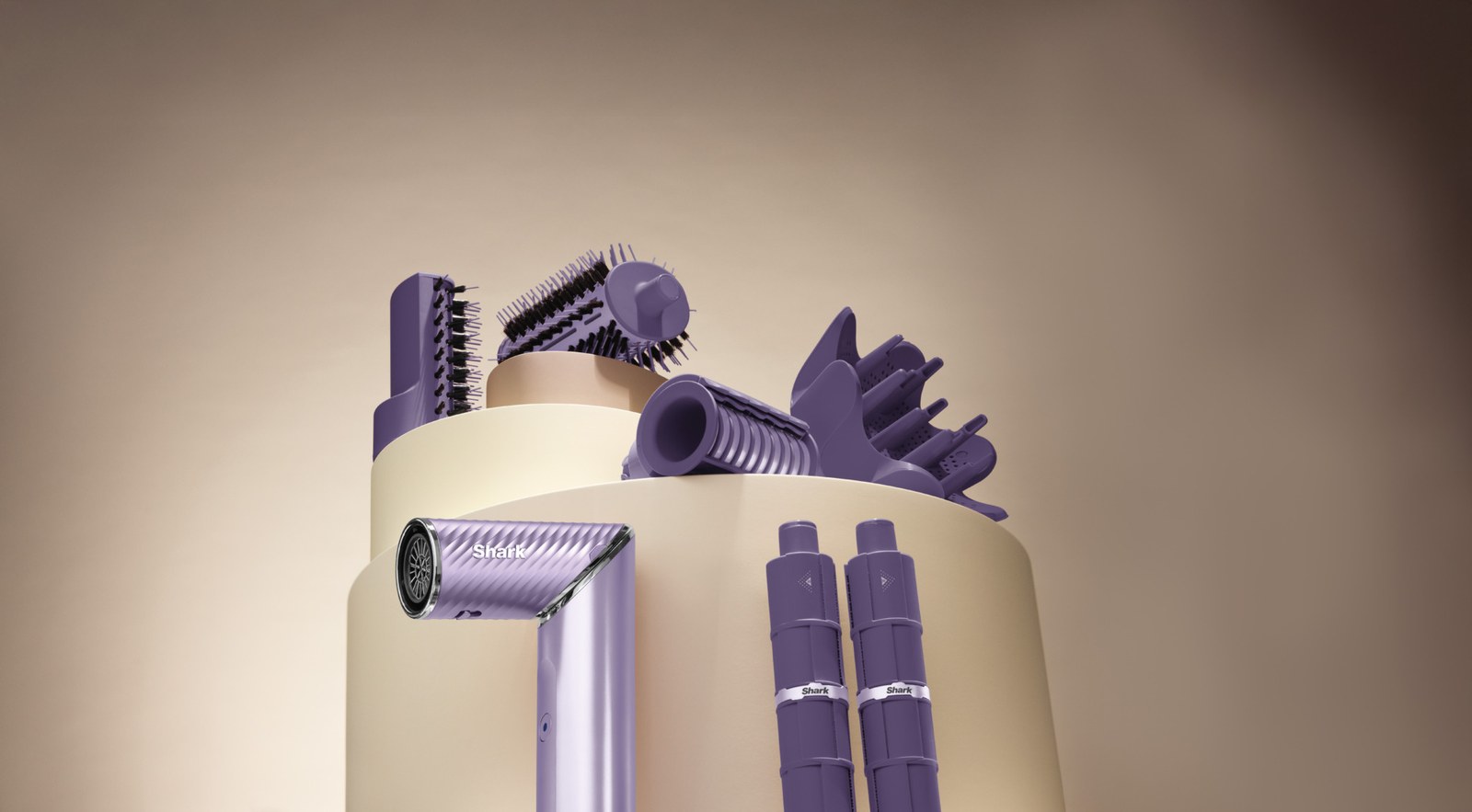 A set of purple Shark FlexStyle hair styling tools and attachments, including a hair dryer, brushes, and IonCurl curling barrels, arranged on a beige circular display against a brown background.