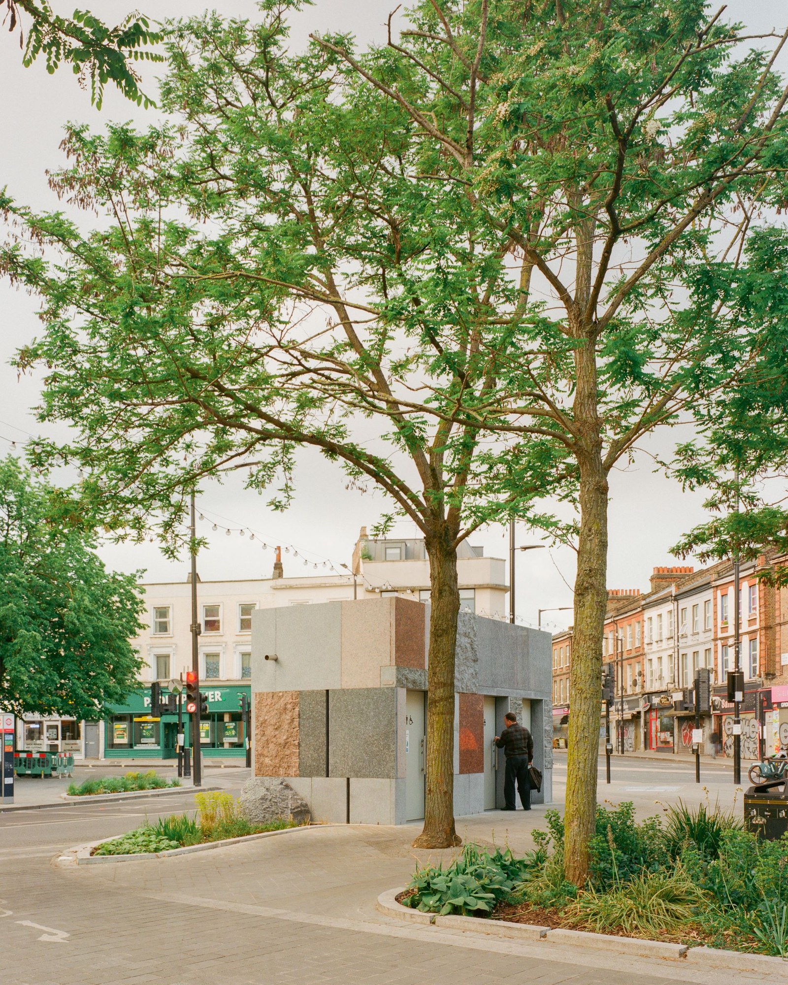 exterior view of Maida Vale public toilet by Studio Weave made out of reclaimed stone, looking like square patchwork