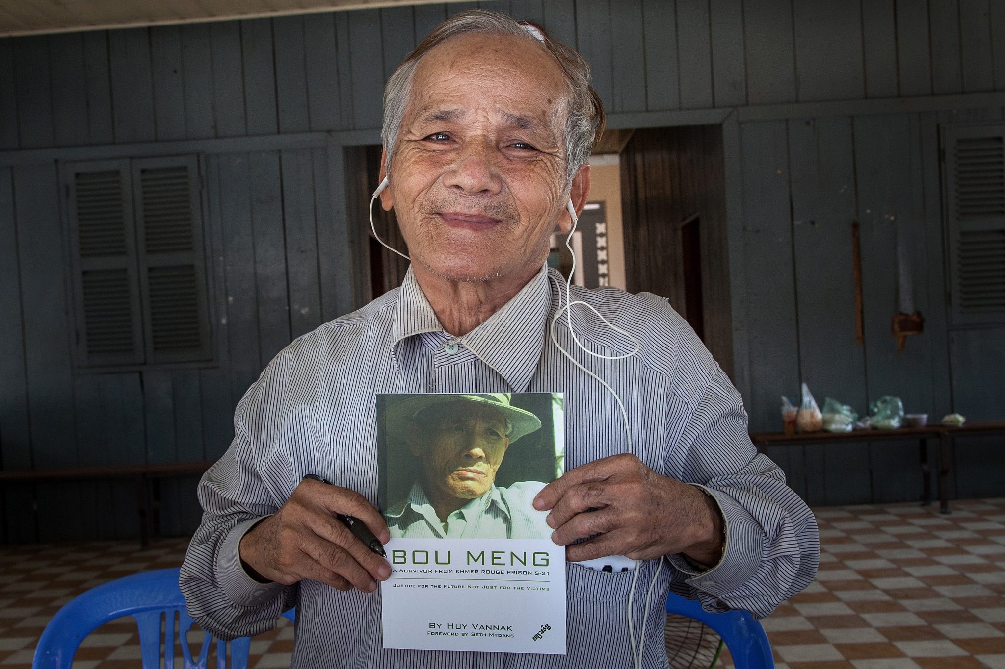 A man holds a book with his face on it