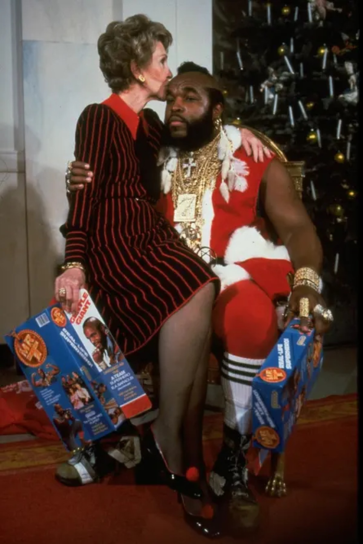 Nancy sits on Mr T’s knee and kisses his forehead