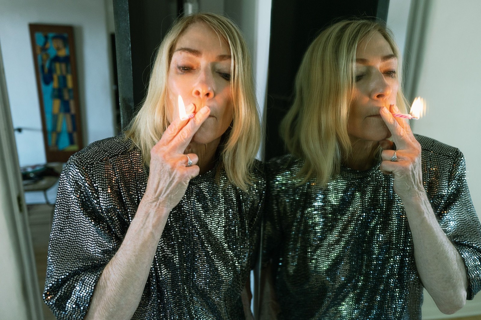 Kim Gordon smoking a birthday candle