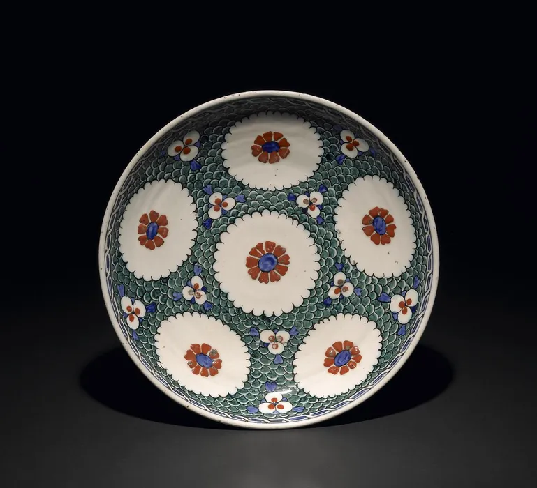 Dish. Cable border at rim and medallions and triple spot designs. Made of red (bole) painted and glazed ceramic, pottery. - Bilinmiyor