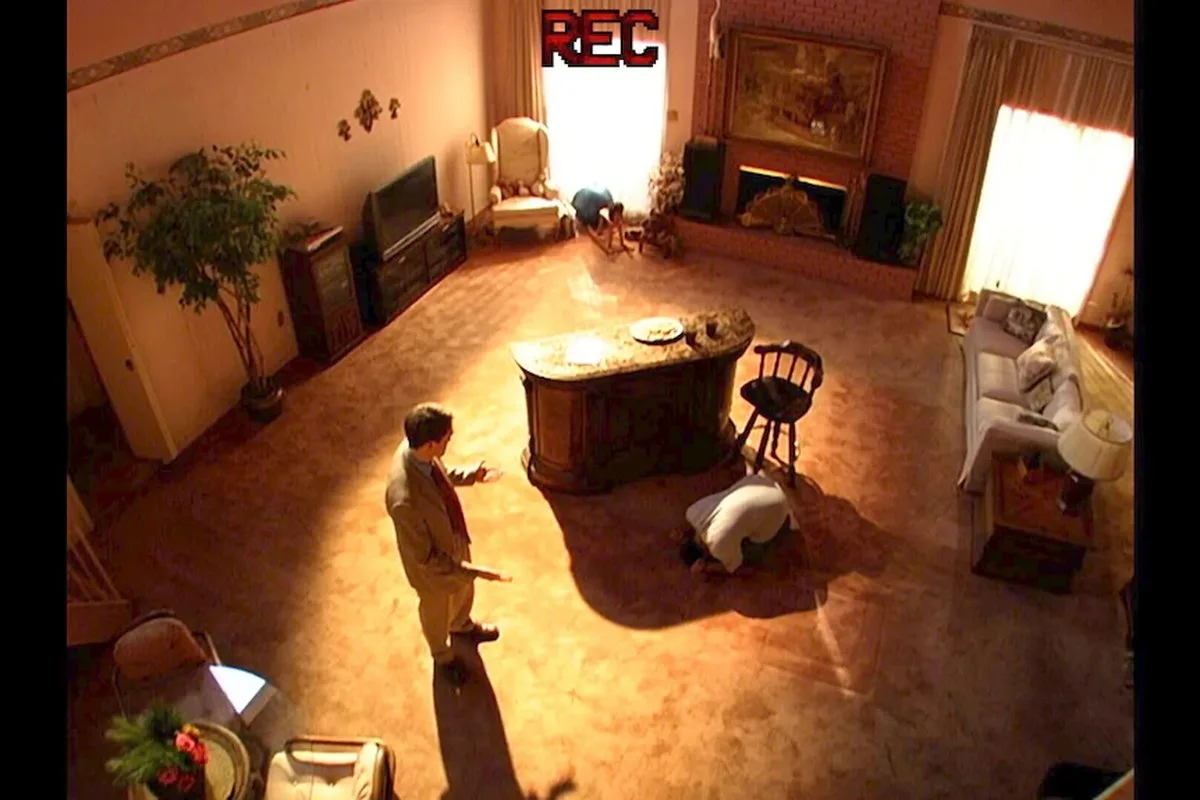 Two men stand in a lounge room