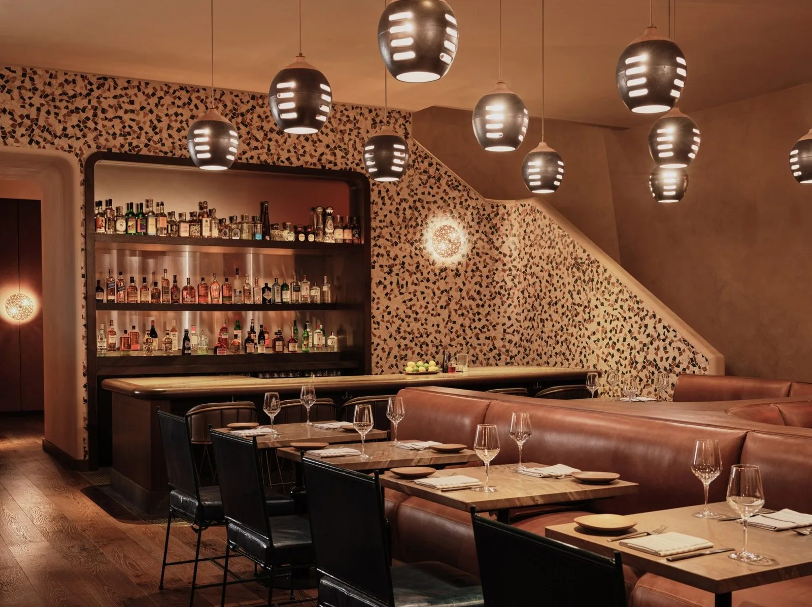 Terracotta-toned walls and ceramic pendants add texture a the restaurant