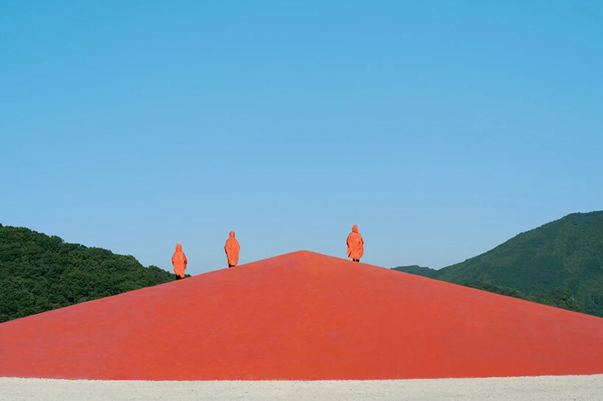 ryue nishizawa places vivid orange peak against turquoise landfill in japan - 1