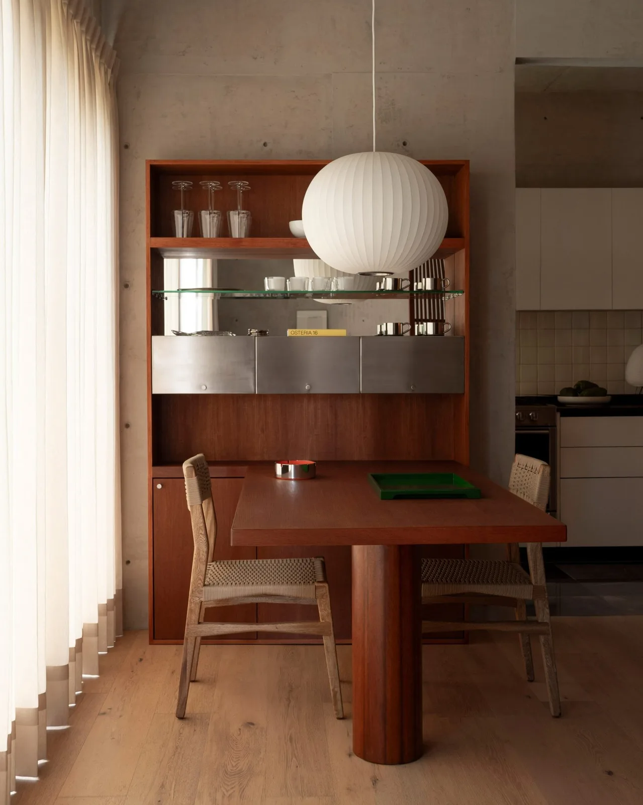 A dining table extending from a shelving unit